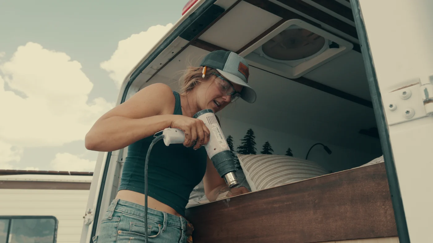 A contestant drills into a wooden interior panel in Gutted season one.