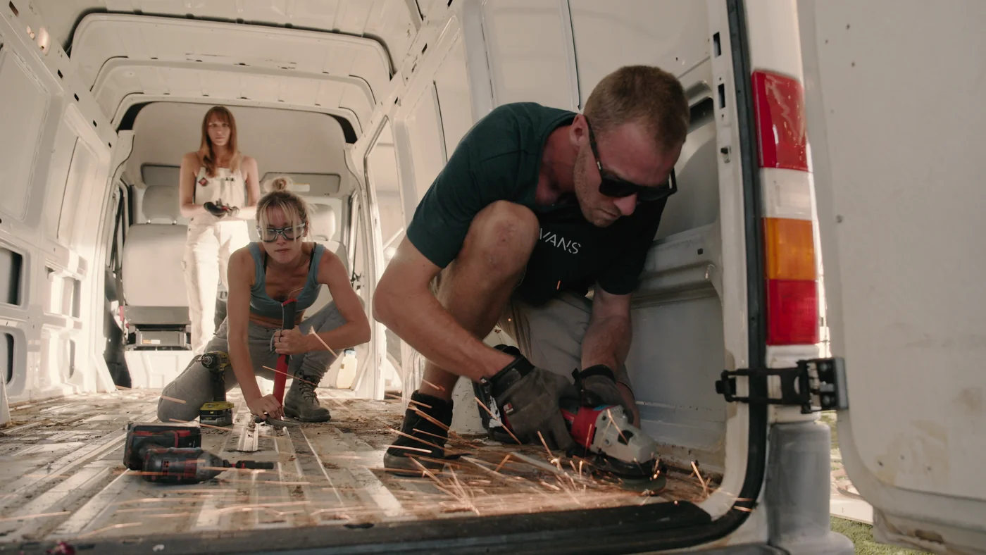 Contestants strip the floor of a van in Gutted season two.