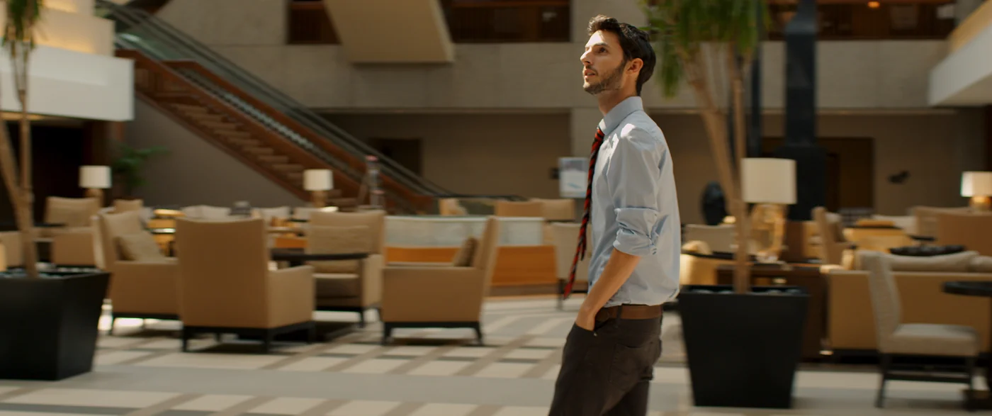 A man crosses a spacious hotel lobby in The Matchbreaker.